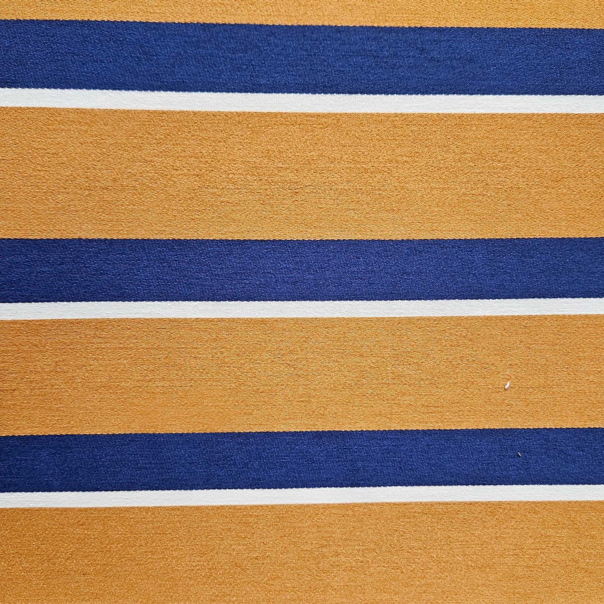 Close-up of fabric with horizontal stripes in gold, blue, and white.