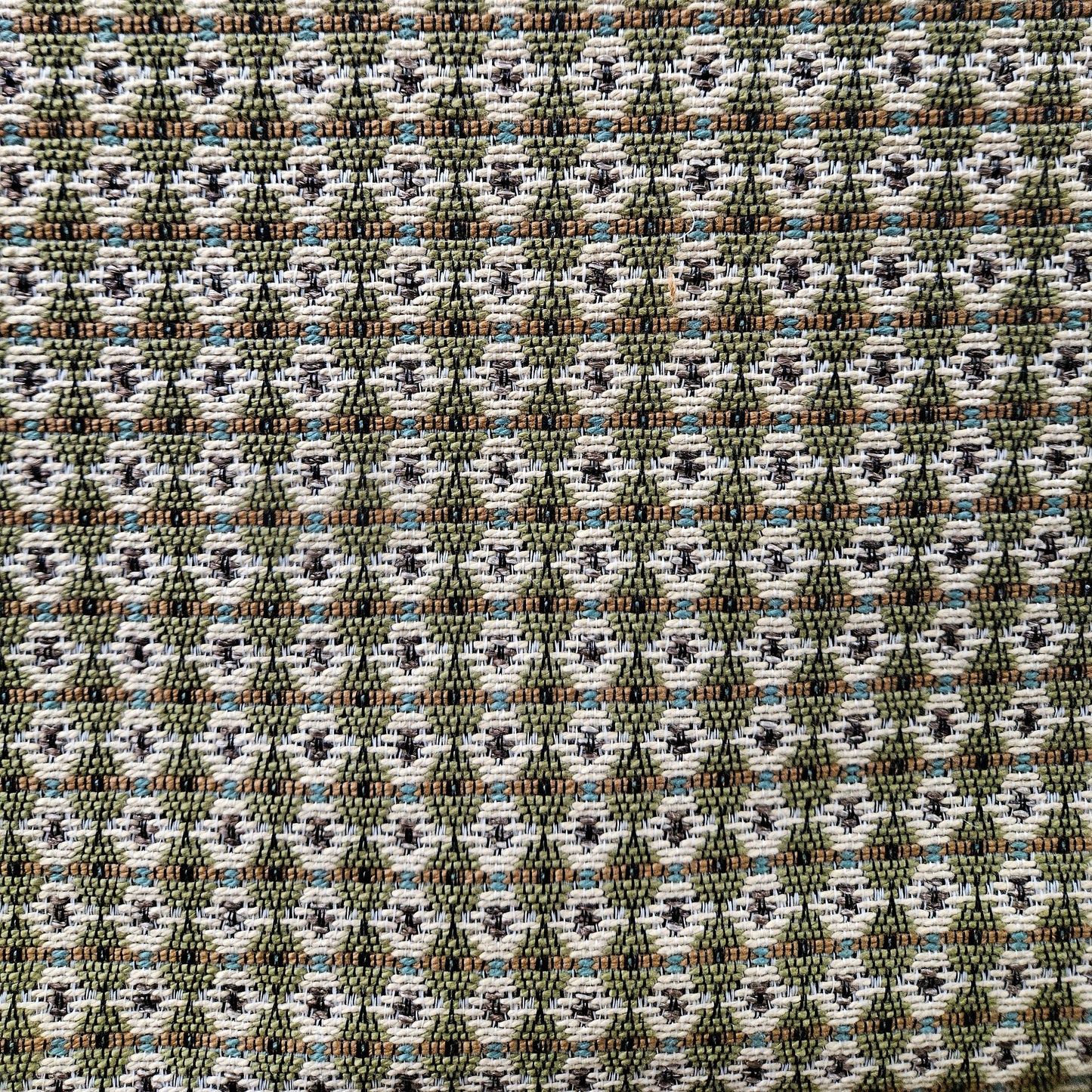Patterned fabric with geometric design in green, brown, and white