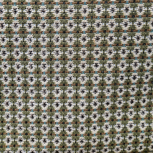 Patterned fabric with geometric design in green, brown, and white