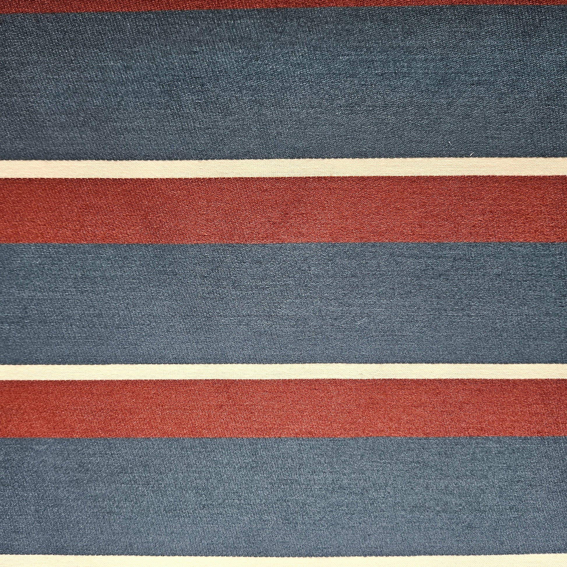 Textured fabric with horizontal stripes in red, blue, and beige.